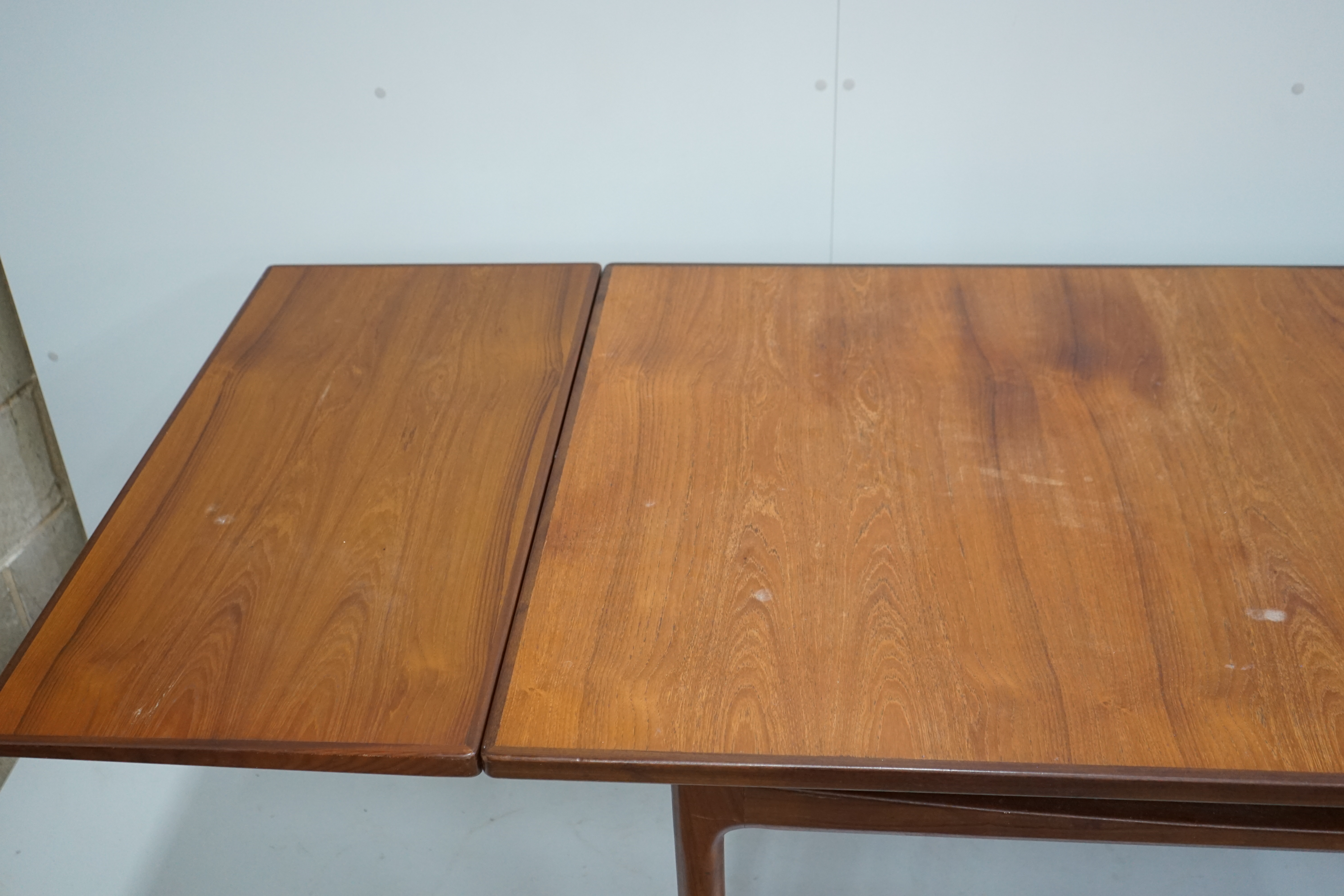 Henning Kjaernulf for Bruno Hansen, four Model 225 'Wishbone' teak dining chairs, width 55cm, depth 44cm, height 64cm and a rectangular extending teak dining table, 244cm extended, width 89cm, height 72cm